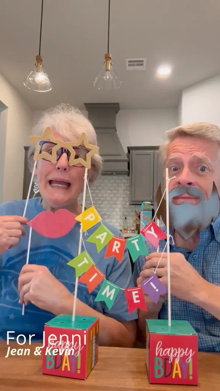 Jean and Kevin in party props, wishing Jenni a happy birthday